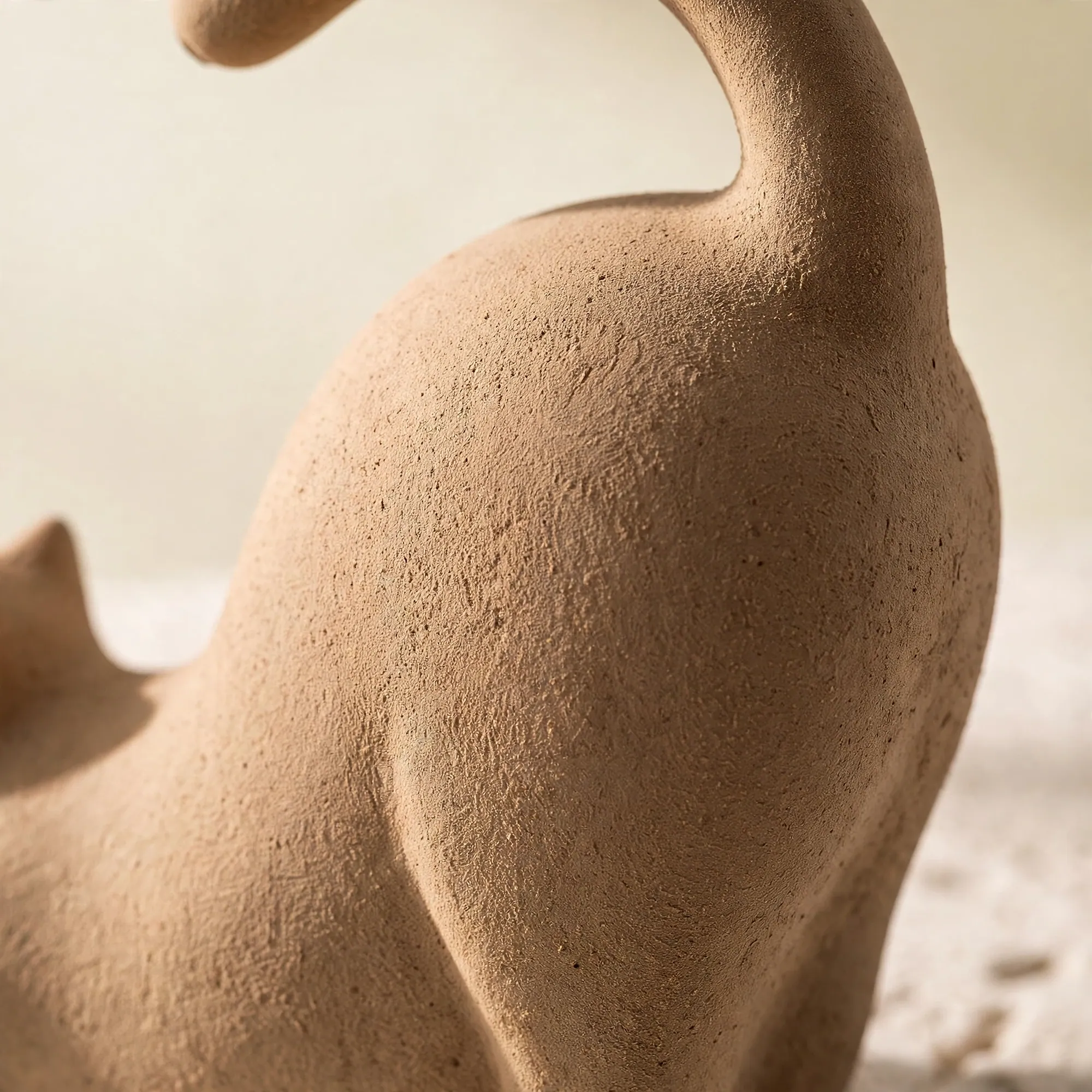 Close-up of the fine matte surface of a cat-shaped incense figure
